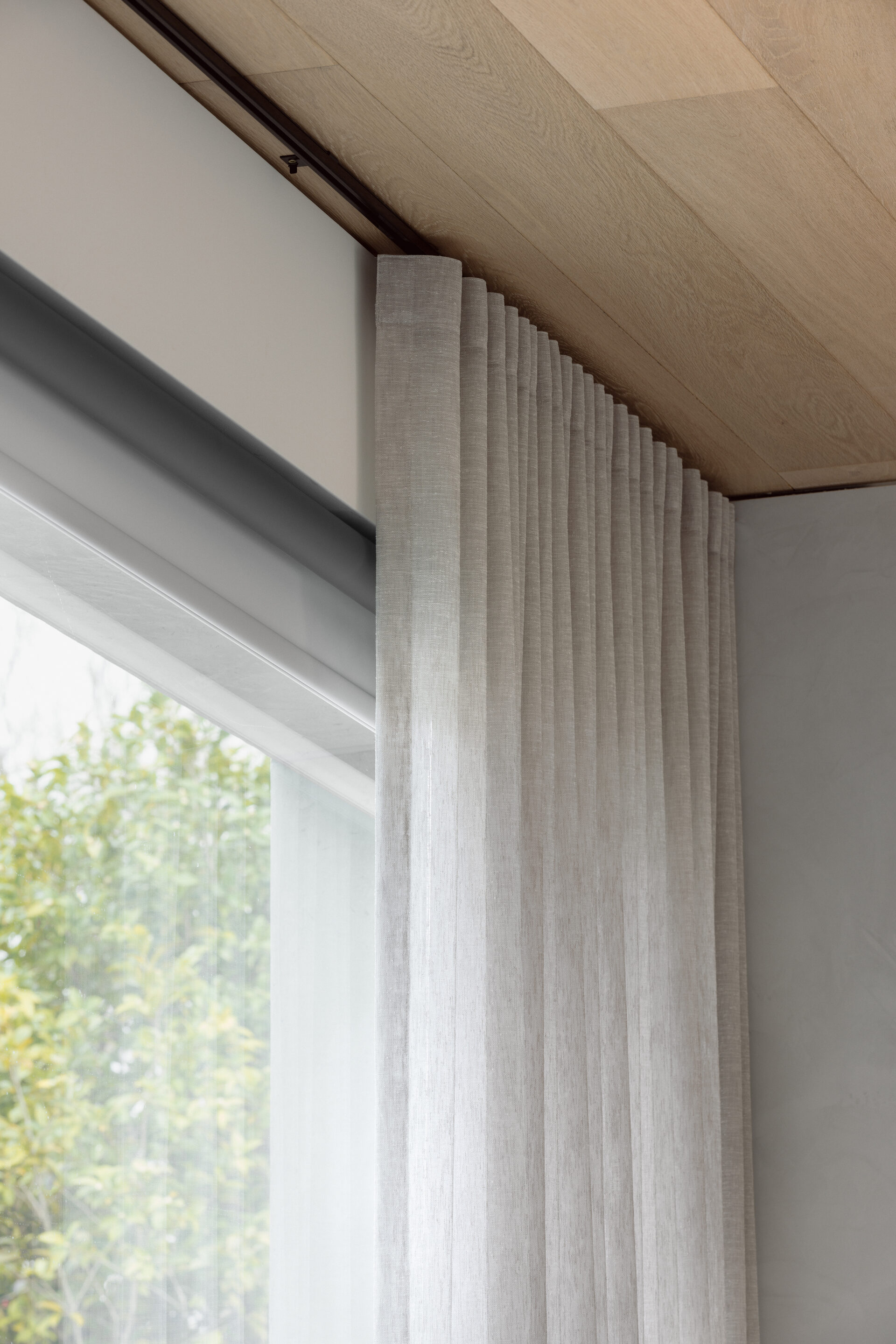 Blockout roller blind paired with sheer curtains in a Berwick bedroom