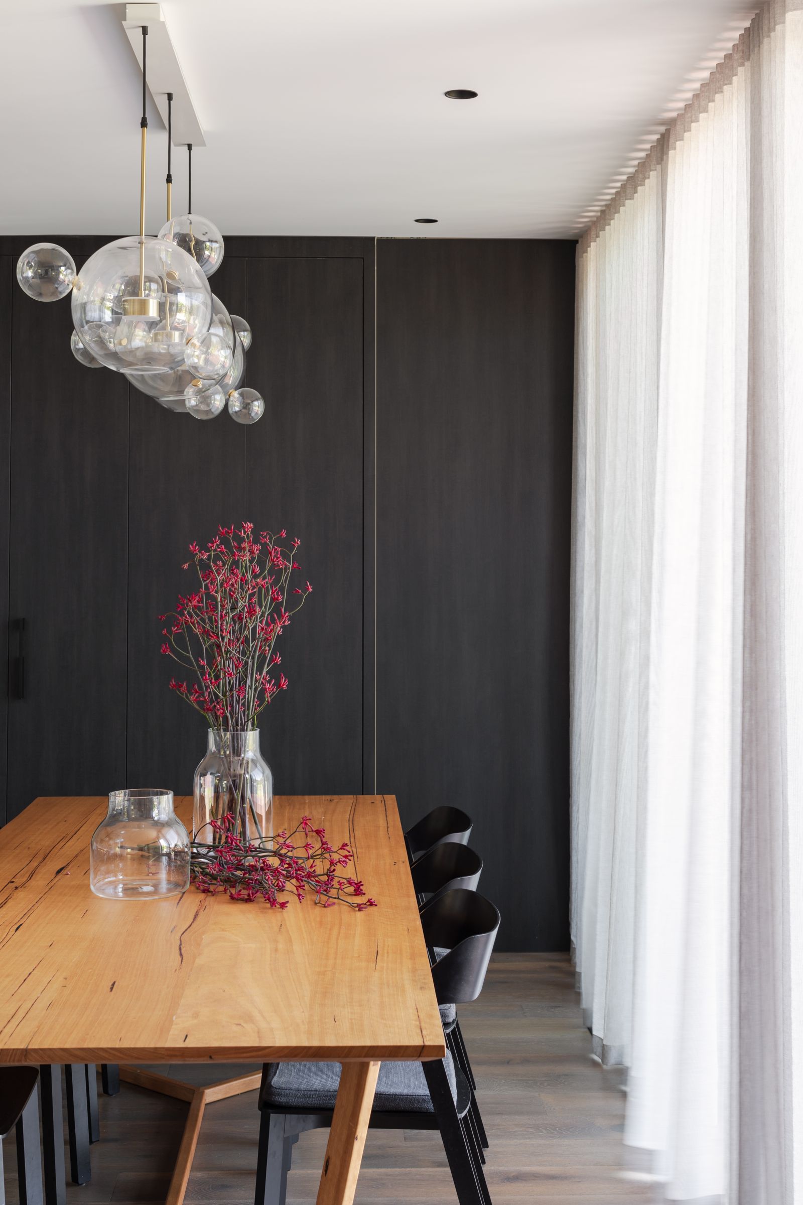 Traditional holdbacks drawing back a master bedroom sheer curtain