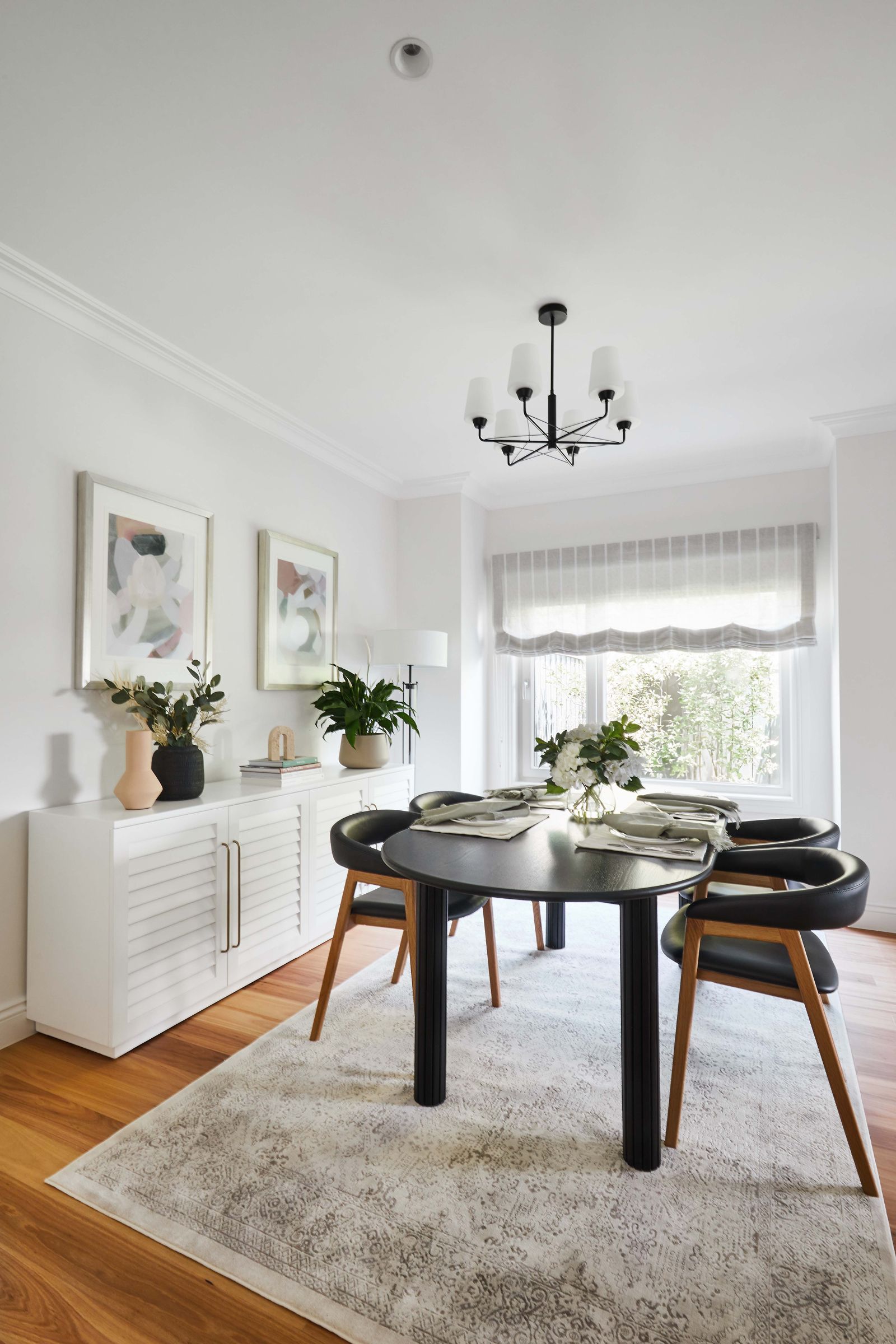 Soft Roman blinds in pinstripe linen on a beach-facing window seat