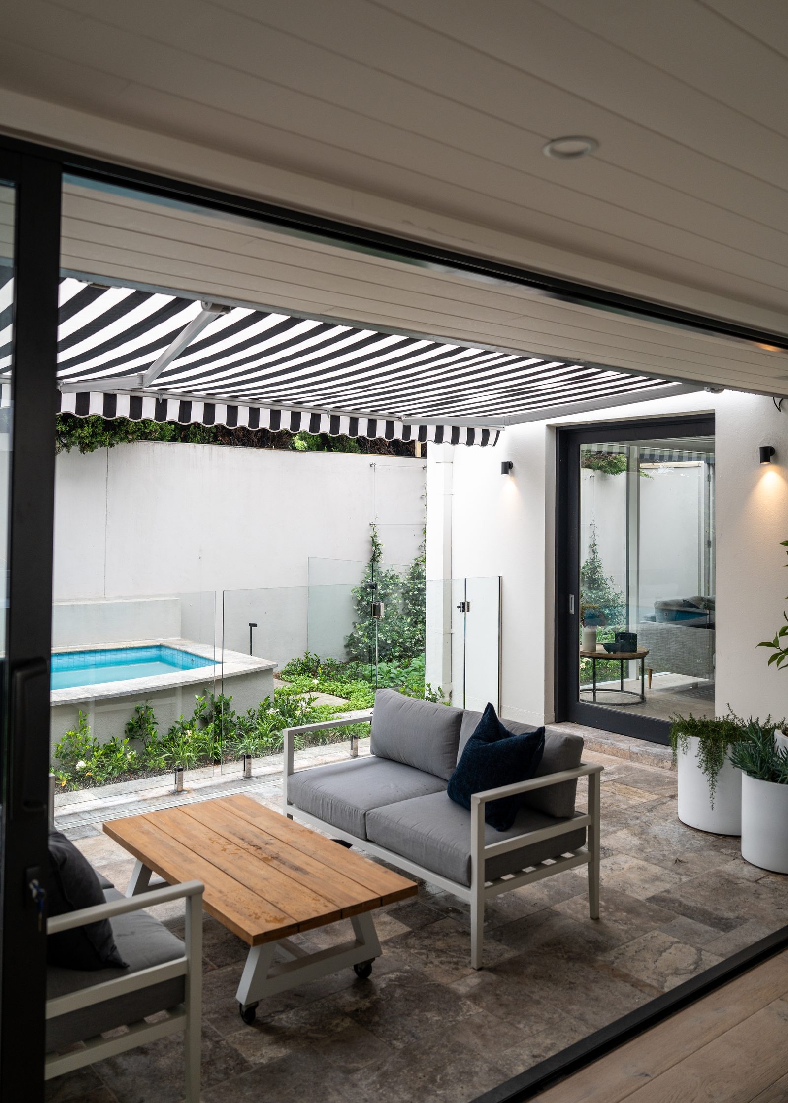 Folding arm awning shading a Melbourne poolside patio