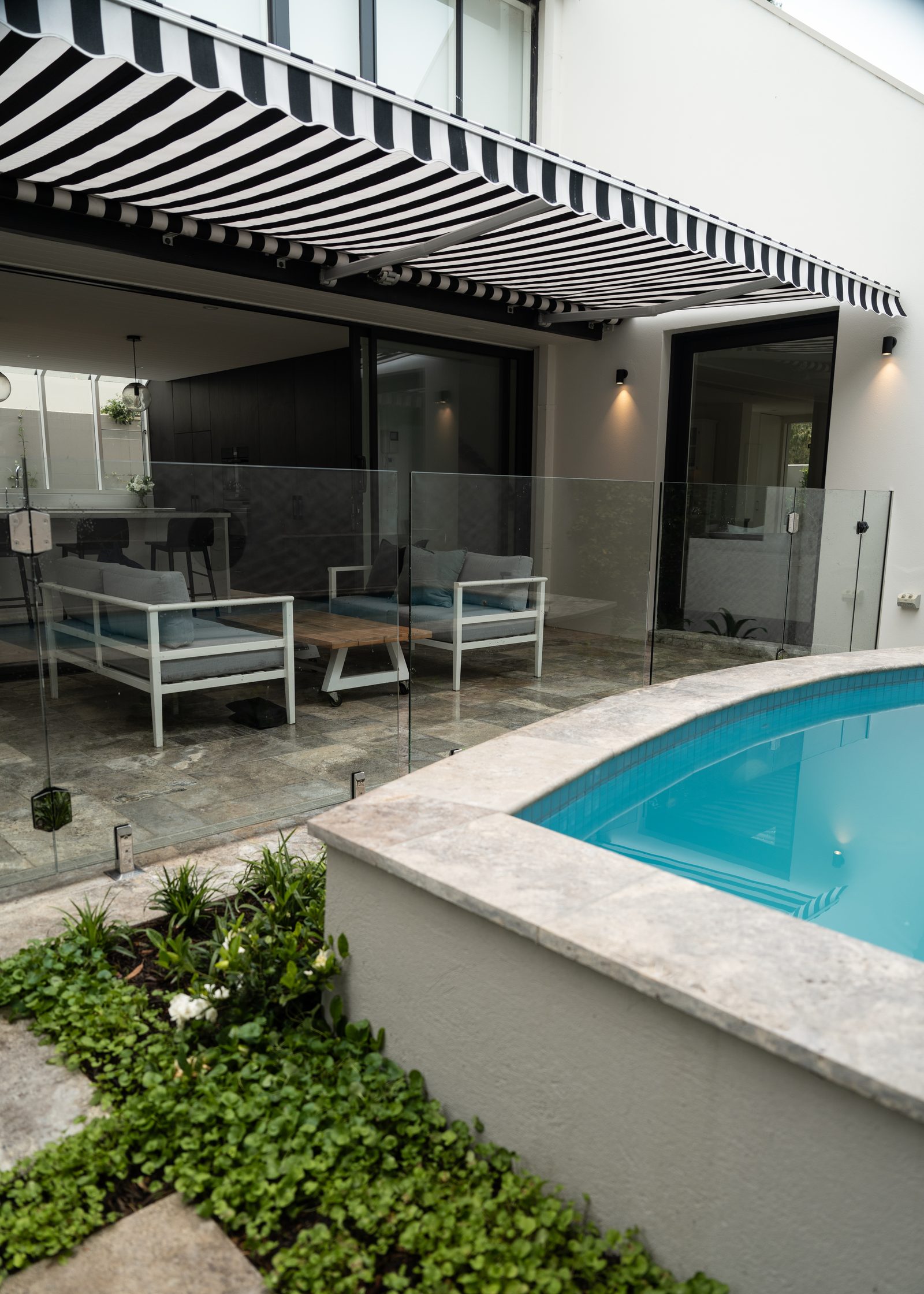 Folding arm awning above a Melbourne poolside alfresco area